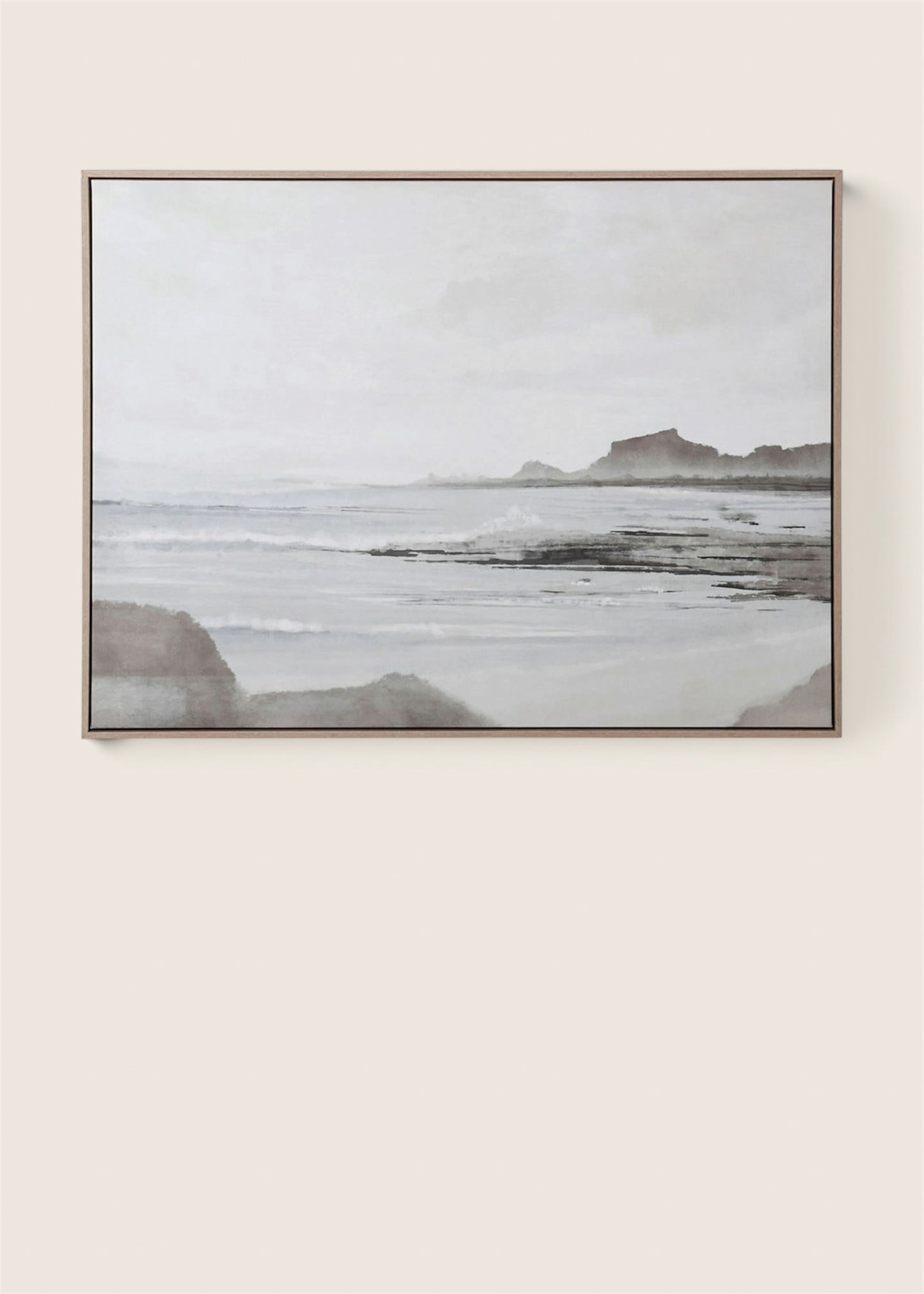 A framed horizontal landscape painting of a misty beach and rocky coastline