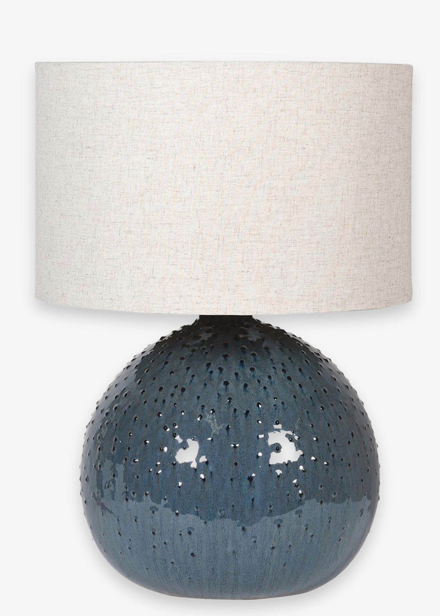 Table lamp with textured blue base and beige lampshade