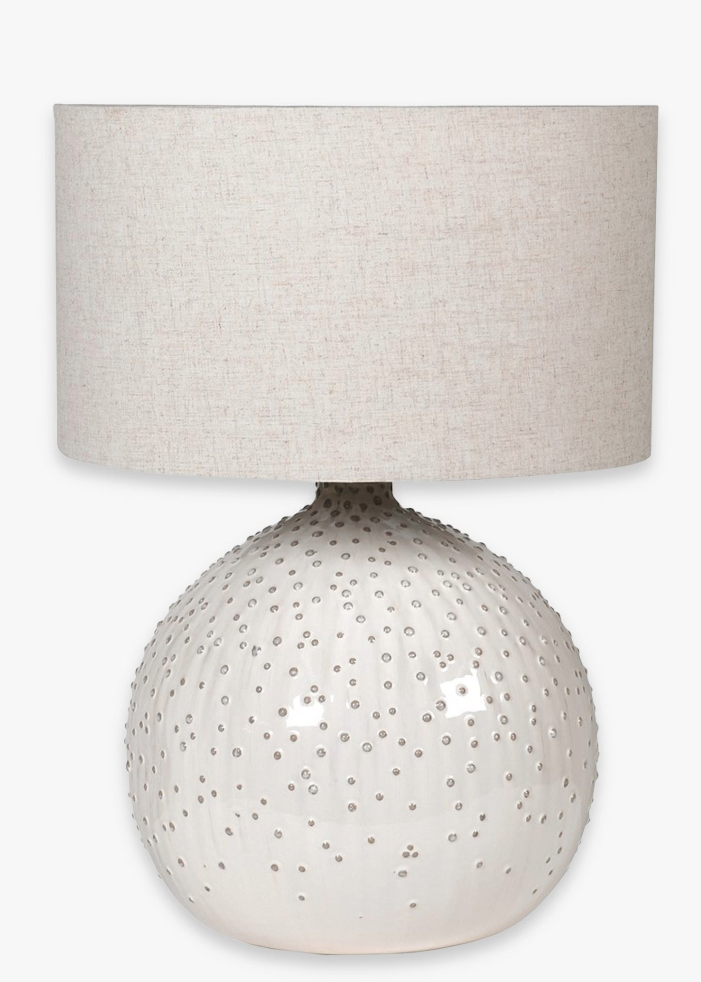 Table lamp with textured ceramic base and beige fabric shade 