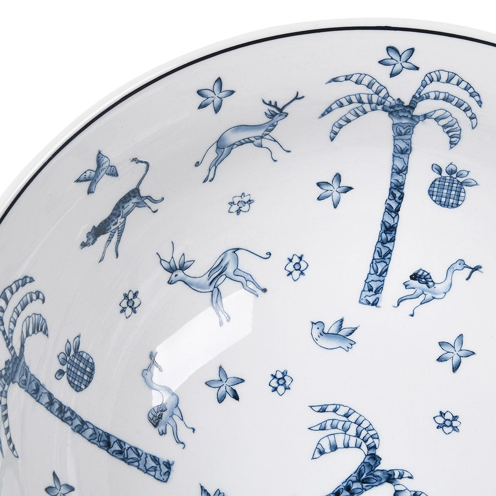 
                      
                        White plate with blue decorative patterns of animals and plants on a white background
                      
                    