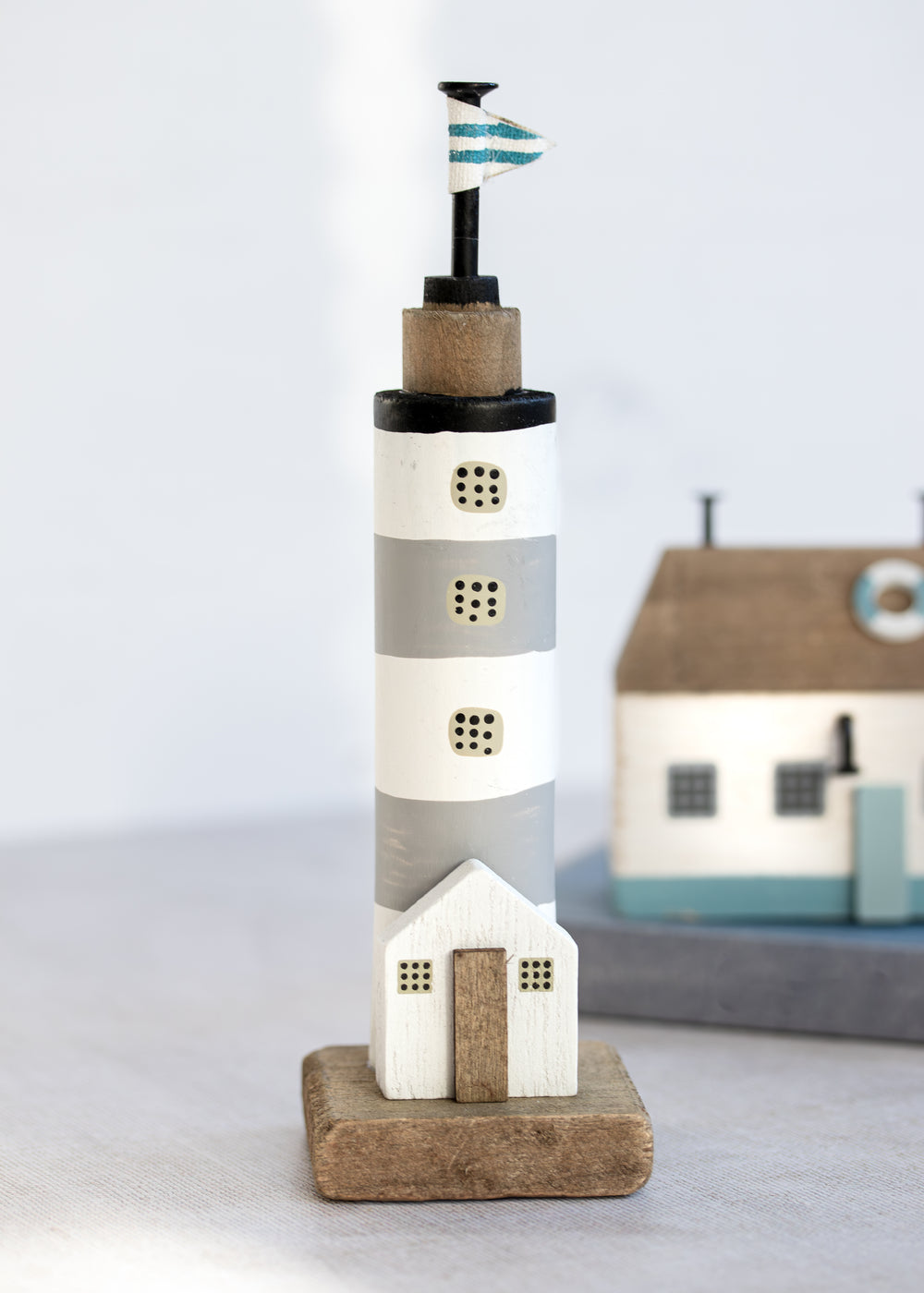 Grey and White Stripe Lighthouse with Flag