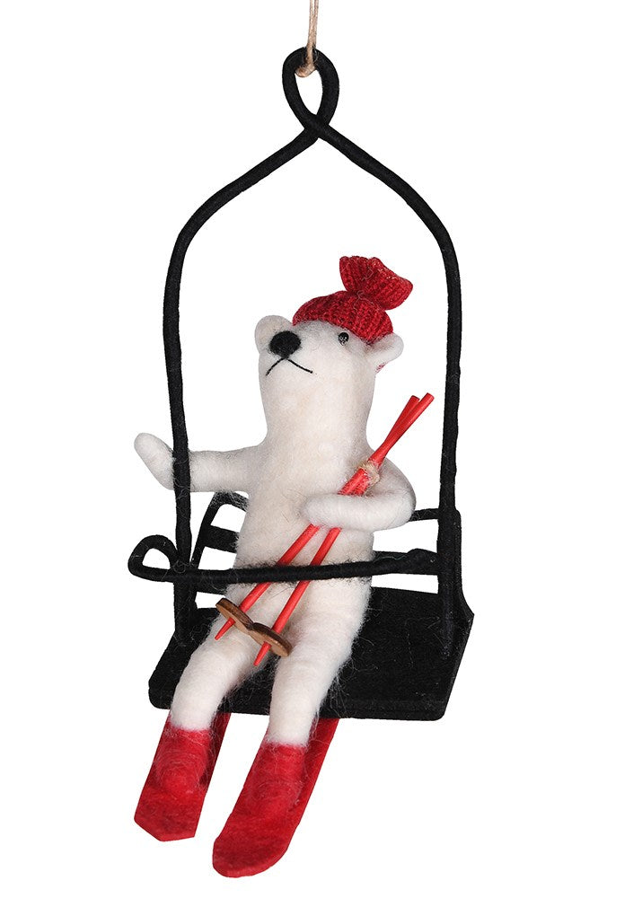 
                      
                        Decorative ornament of a polar bear in a ski lift with skis and a red hat .
                      
                    