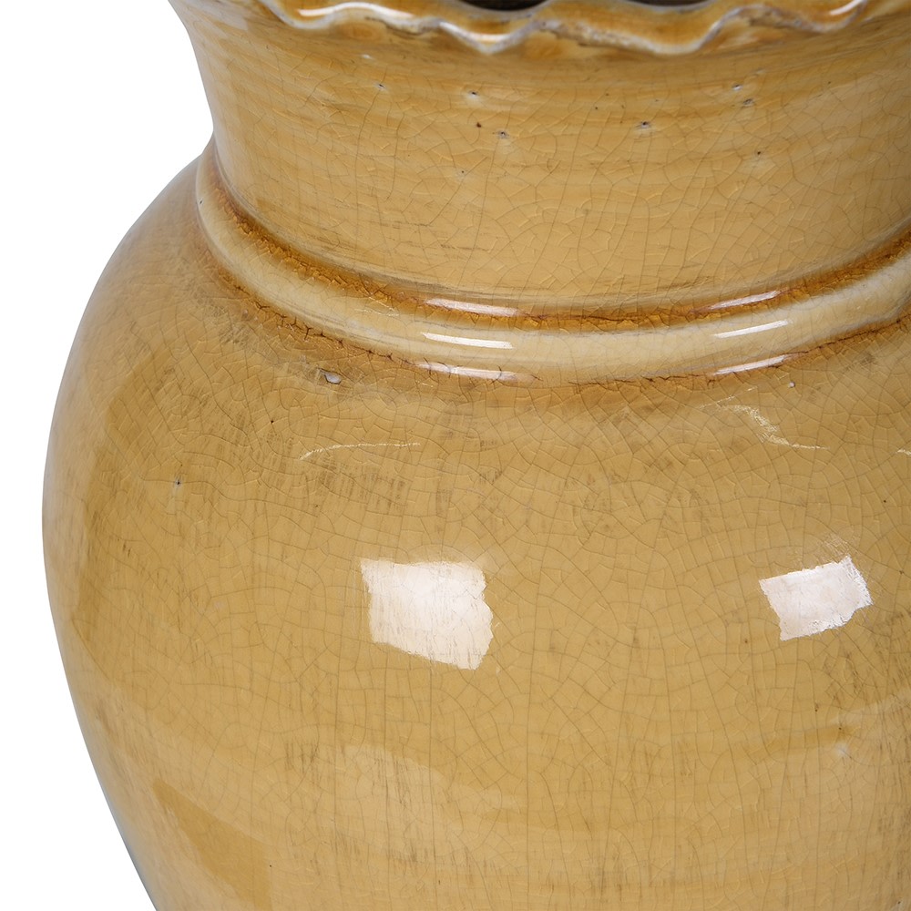 
                      
                        Close-up of a ochre toned ceramic vase with a textured surface
                      
                    