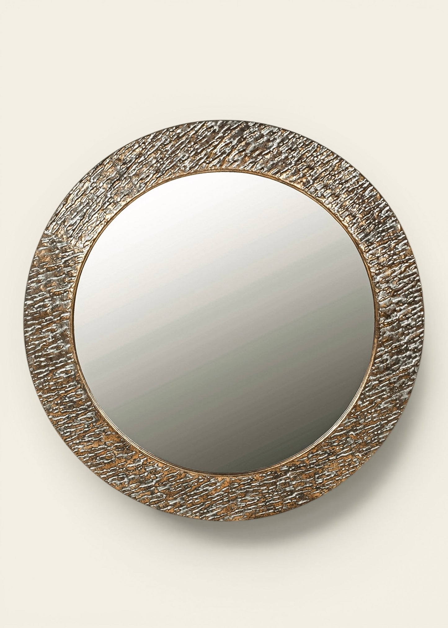 Round wall mirror with a textured gold metallic frame 