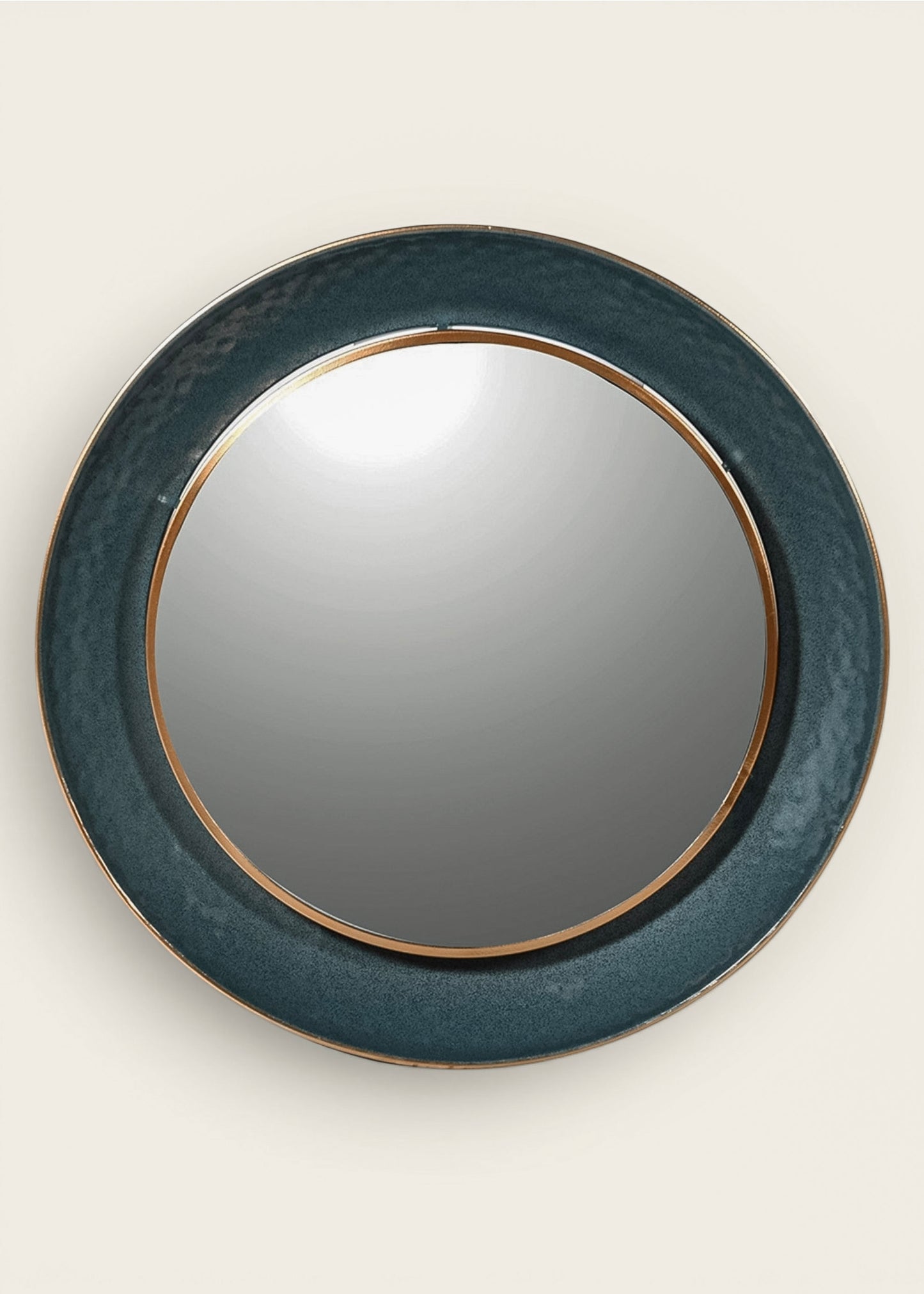 Round wall mirror with a textured dark teal-blue frame and a thin gold inner trim