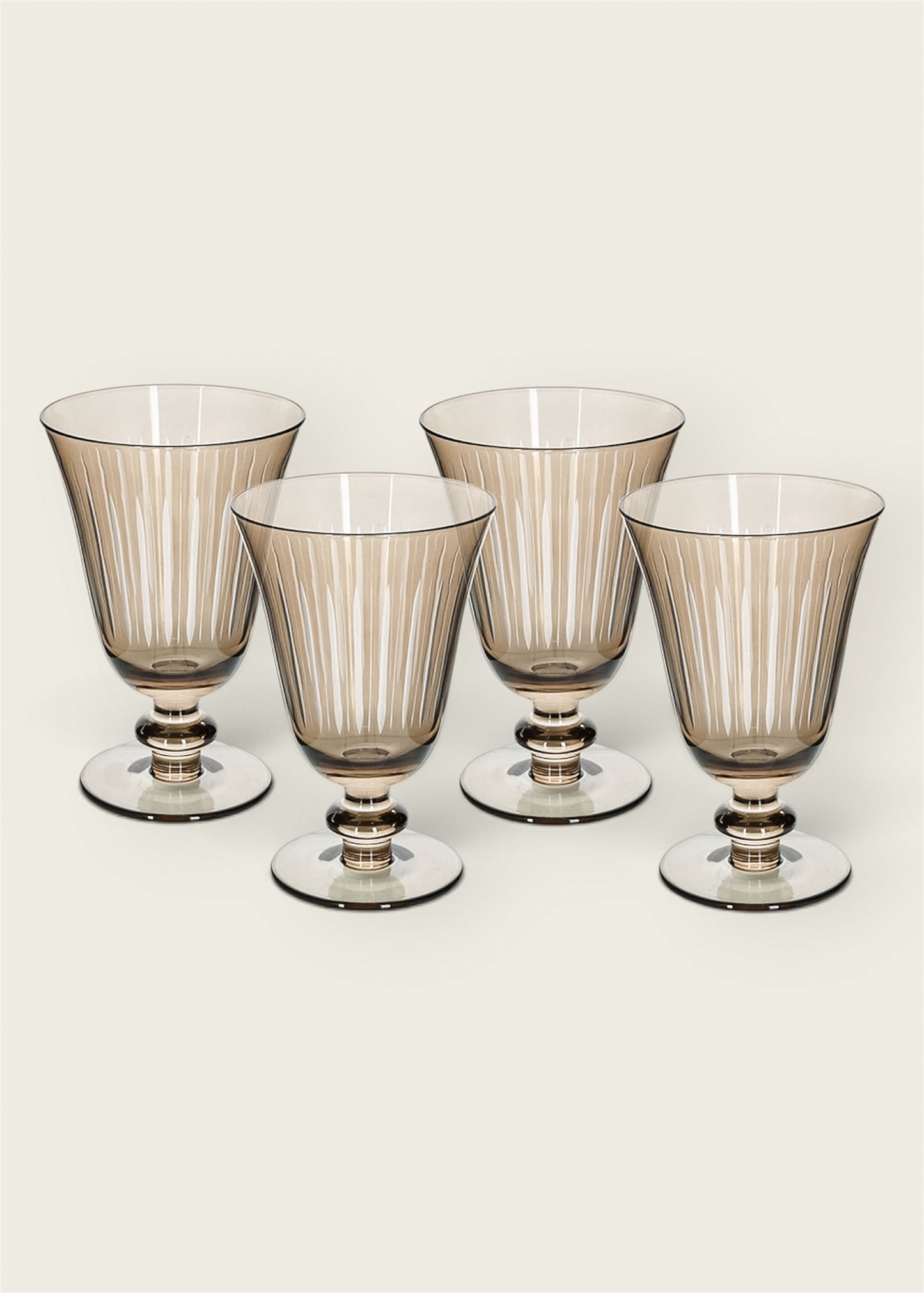 Four oat toned glass goblets with vertical fluted detailing