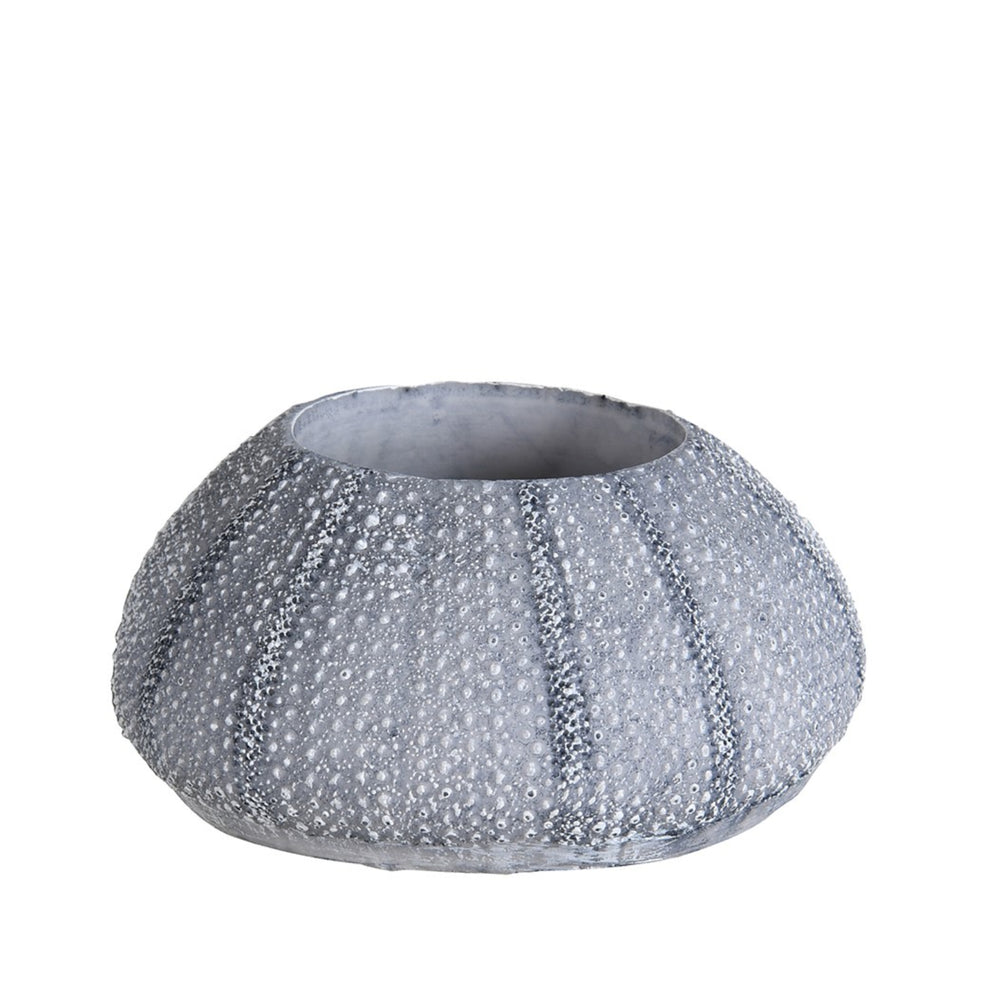 
                      
                        Decorative blue candle holder with sea urchin design for beach-themed interiors
                      
                    